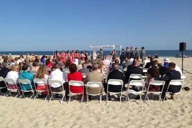 wedding guests at a beach ceremony with sound
