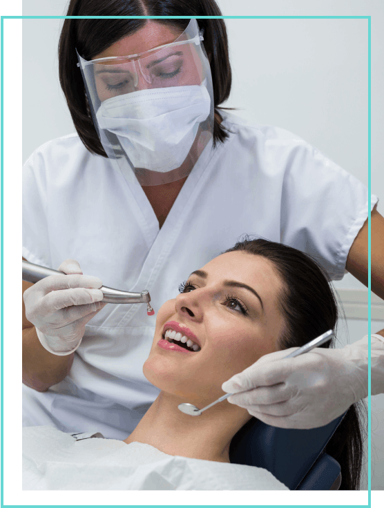 A dental hygienist trained in sedation dentistry cleaning a patient's teeth in London, ON