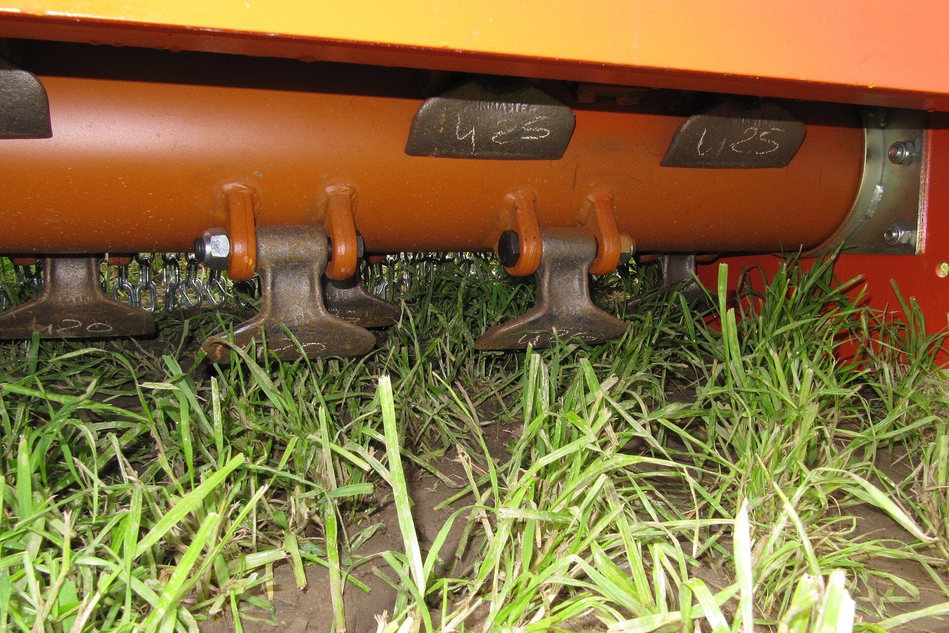 Close up view of flails fitted to the rotating drum of a flail mower.