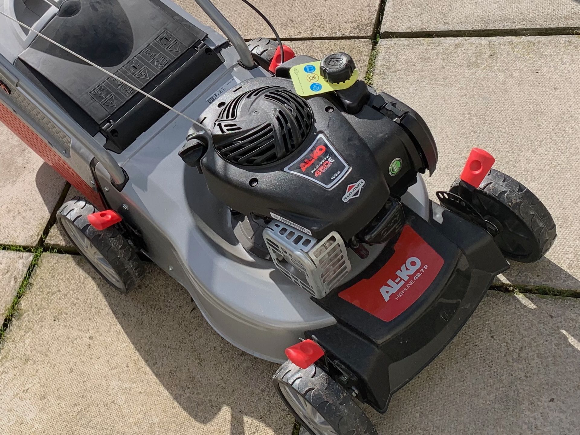 Photograph of an AL-KO Highline petrol engine lawnmower, with multi-point height adjustment.