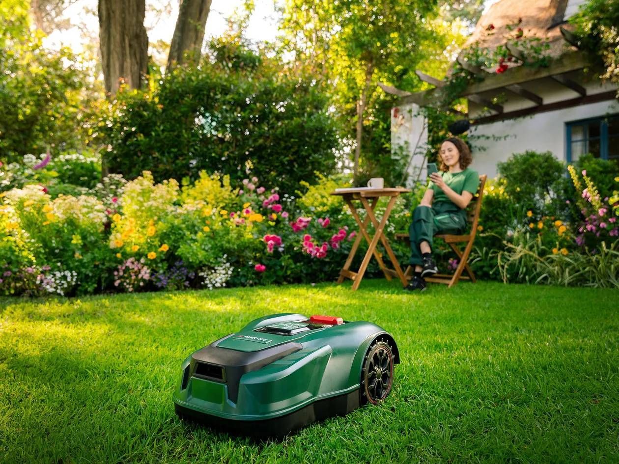 Photograph of a lawn being cut by a Lidl brand Parkside robotic lawnmower.