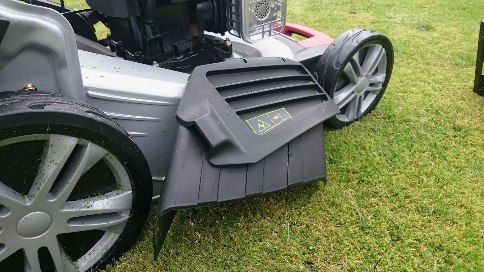 Photograph of the side discharge chute, fitted to a World brand 48cm mower.