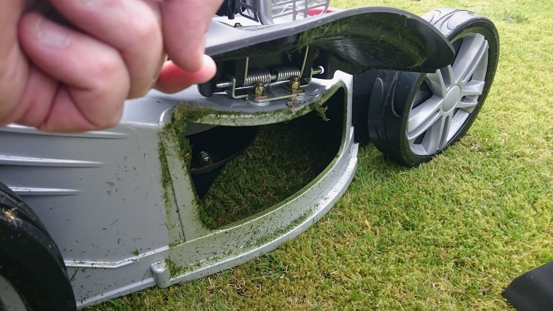 Photograph of a side discharge port, fitted to a World brand, petrol lawnmower.