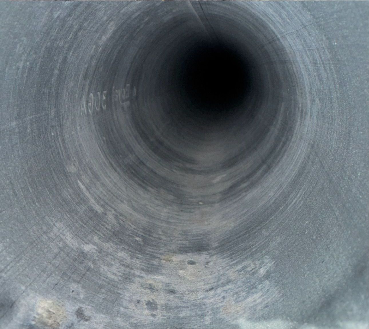 A close up of a metal pipe with a hole in the middle