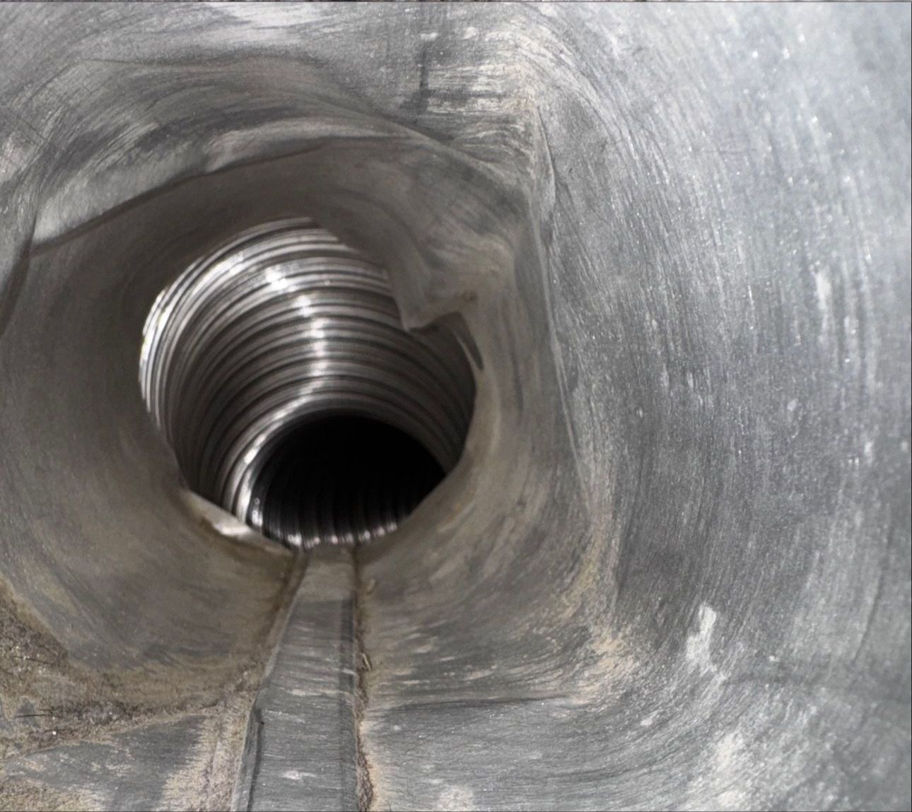 A metal pipe with a hole in the middle of it