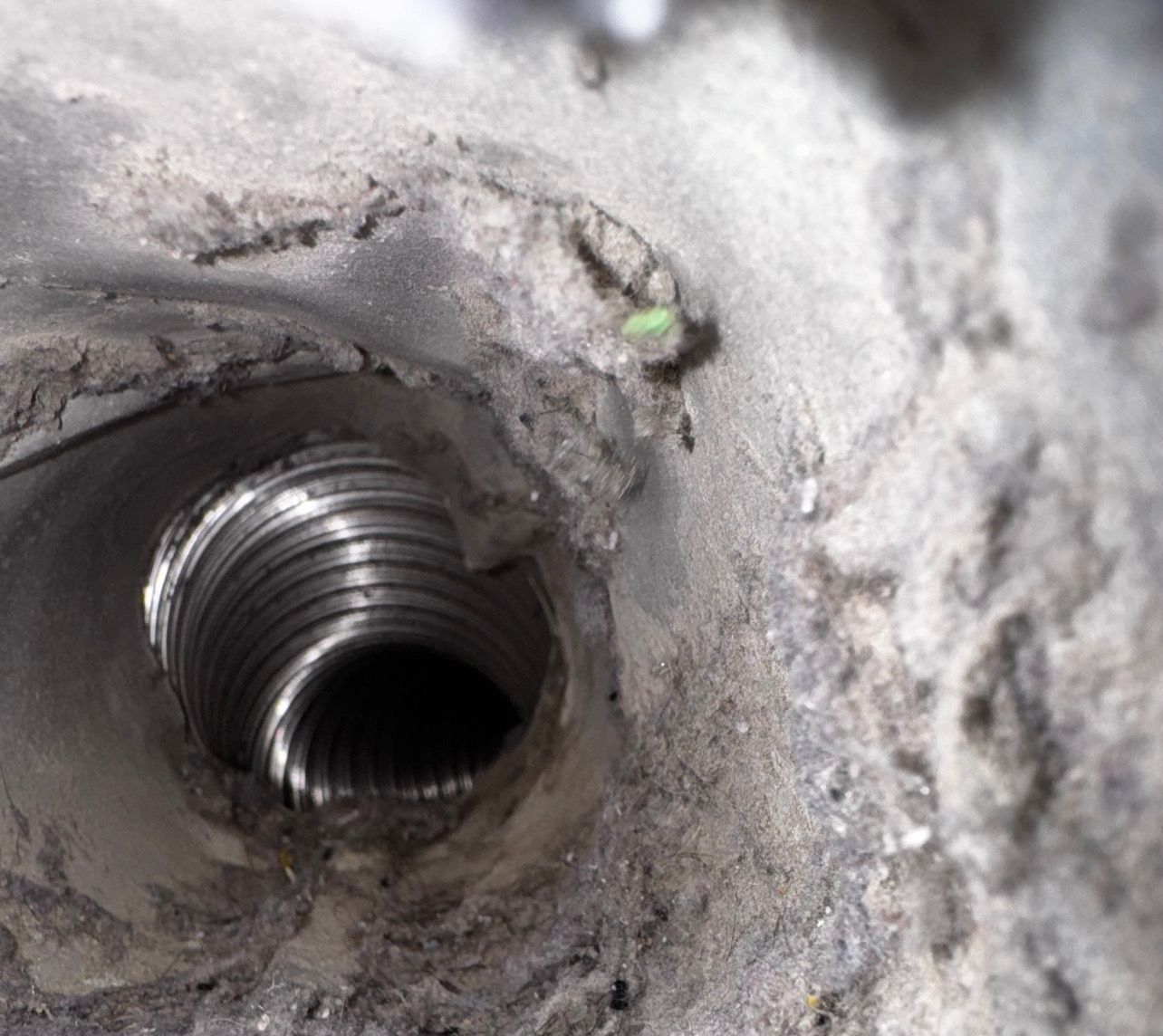 A close up of a hole in a concrete wall