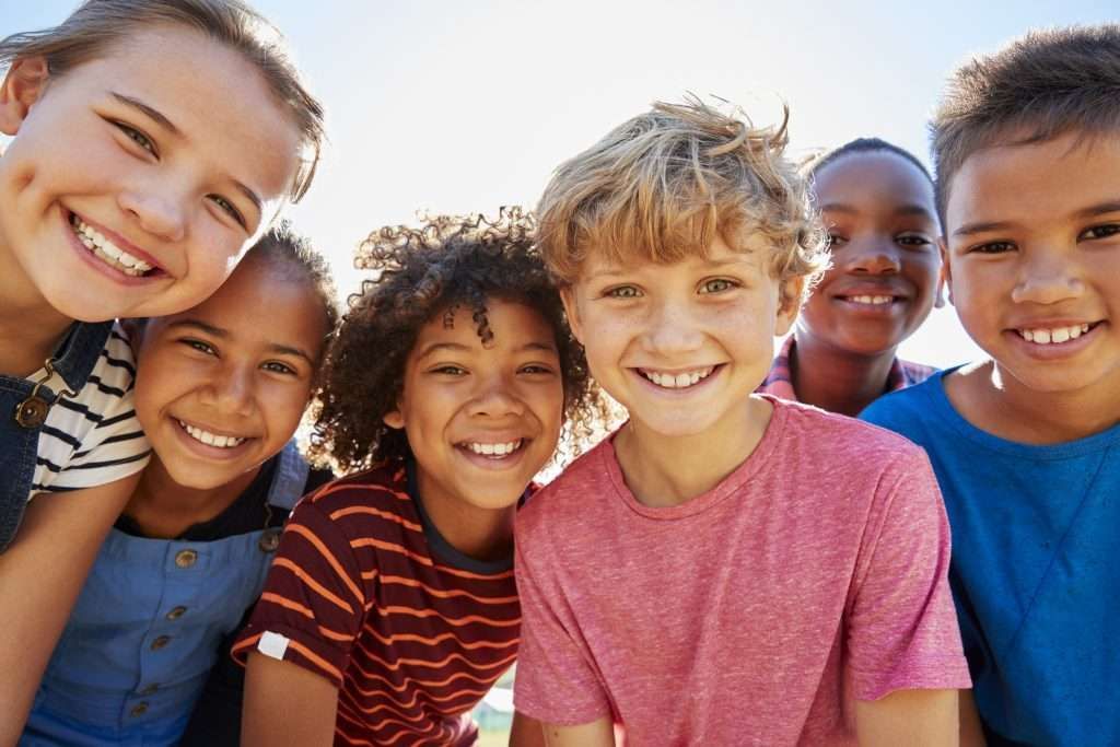 group of kids smiling happy together