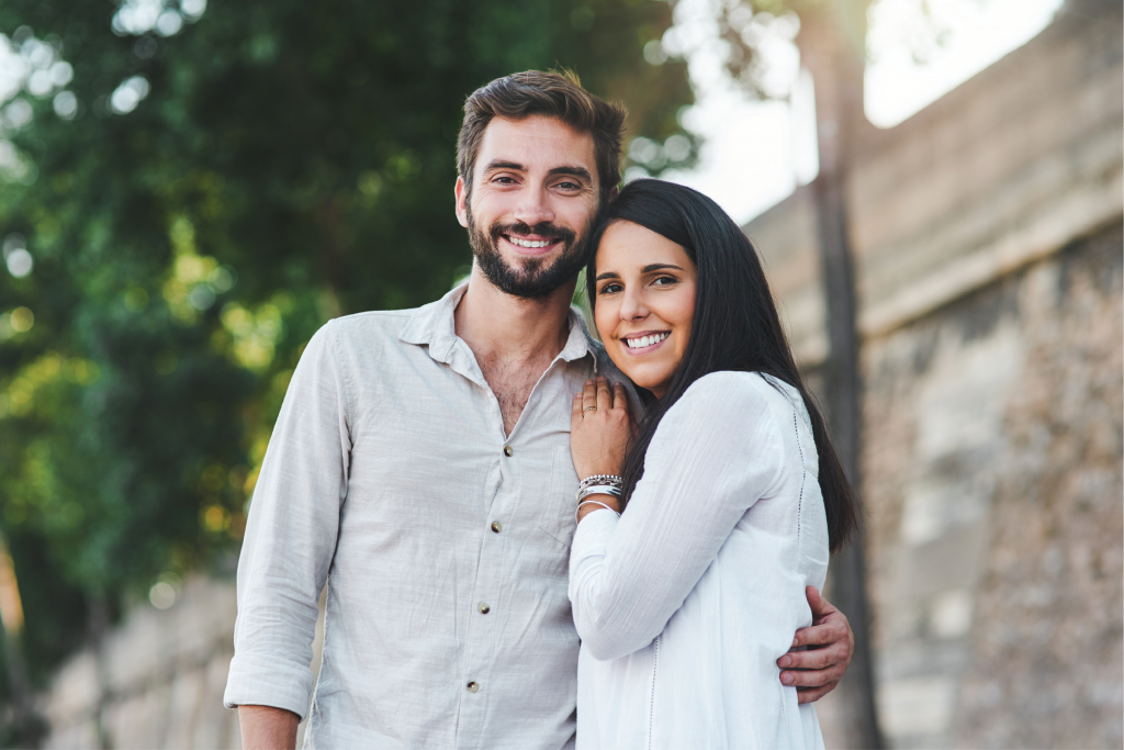 man and woman standing together smiling