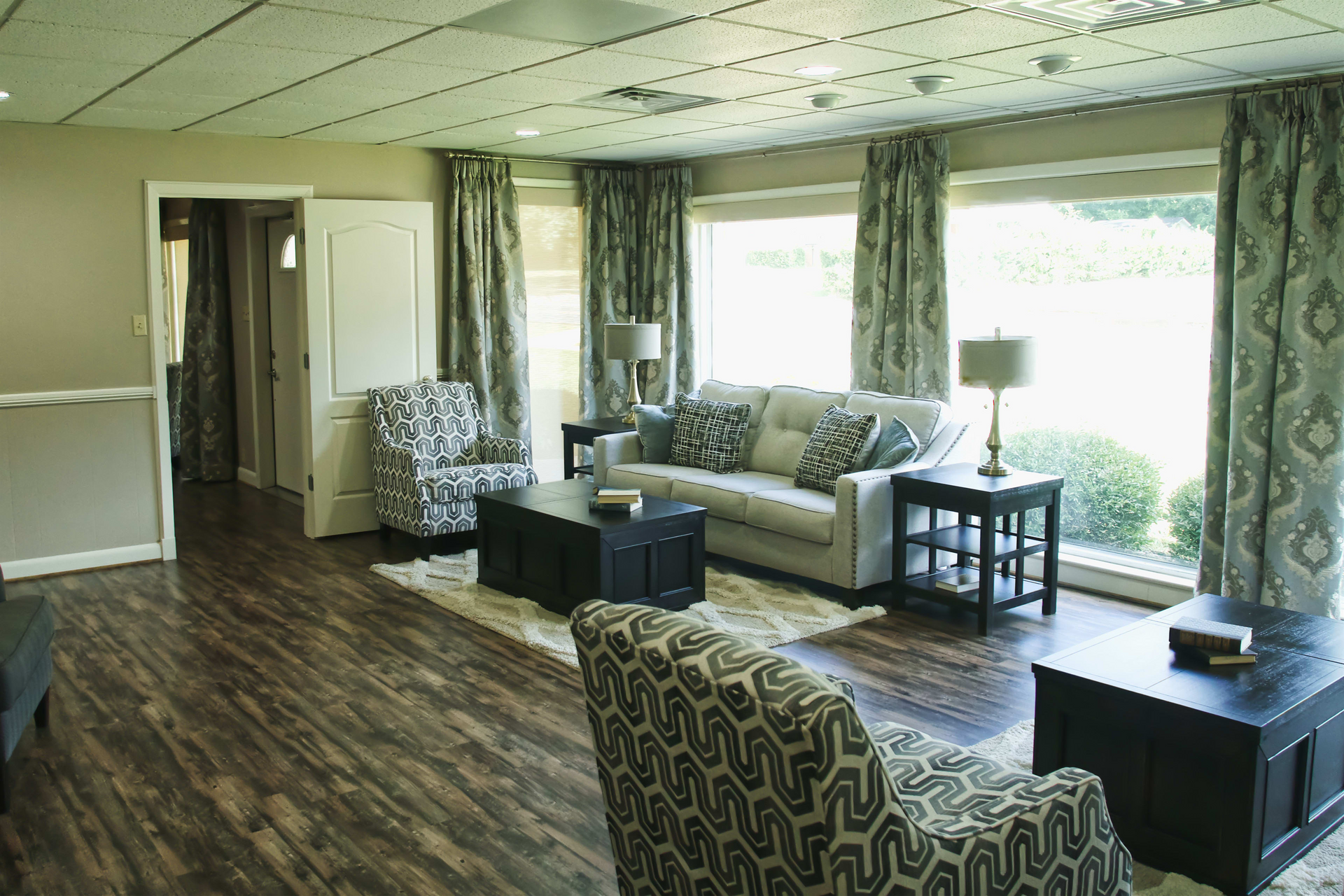 A living room with a couch , chairs , and a coffee table