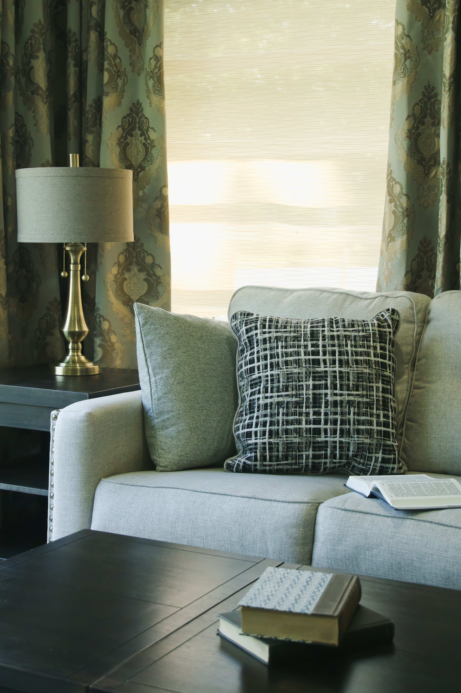 A living room with a couch and a lamp