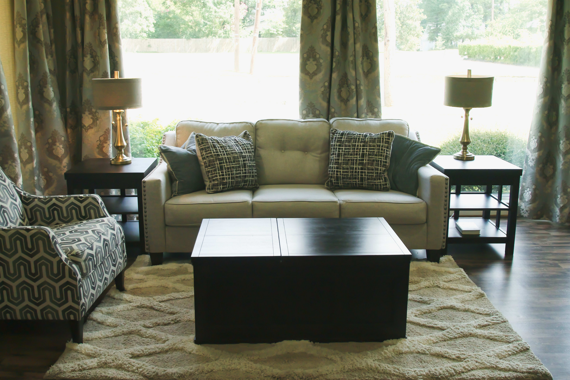 A living room with a couch a chair and a coffee table