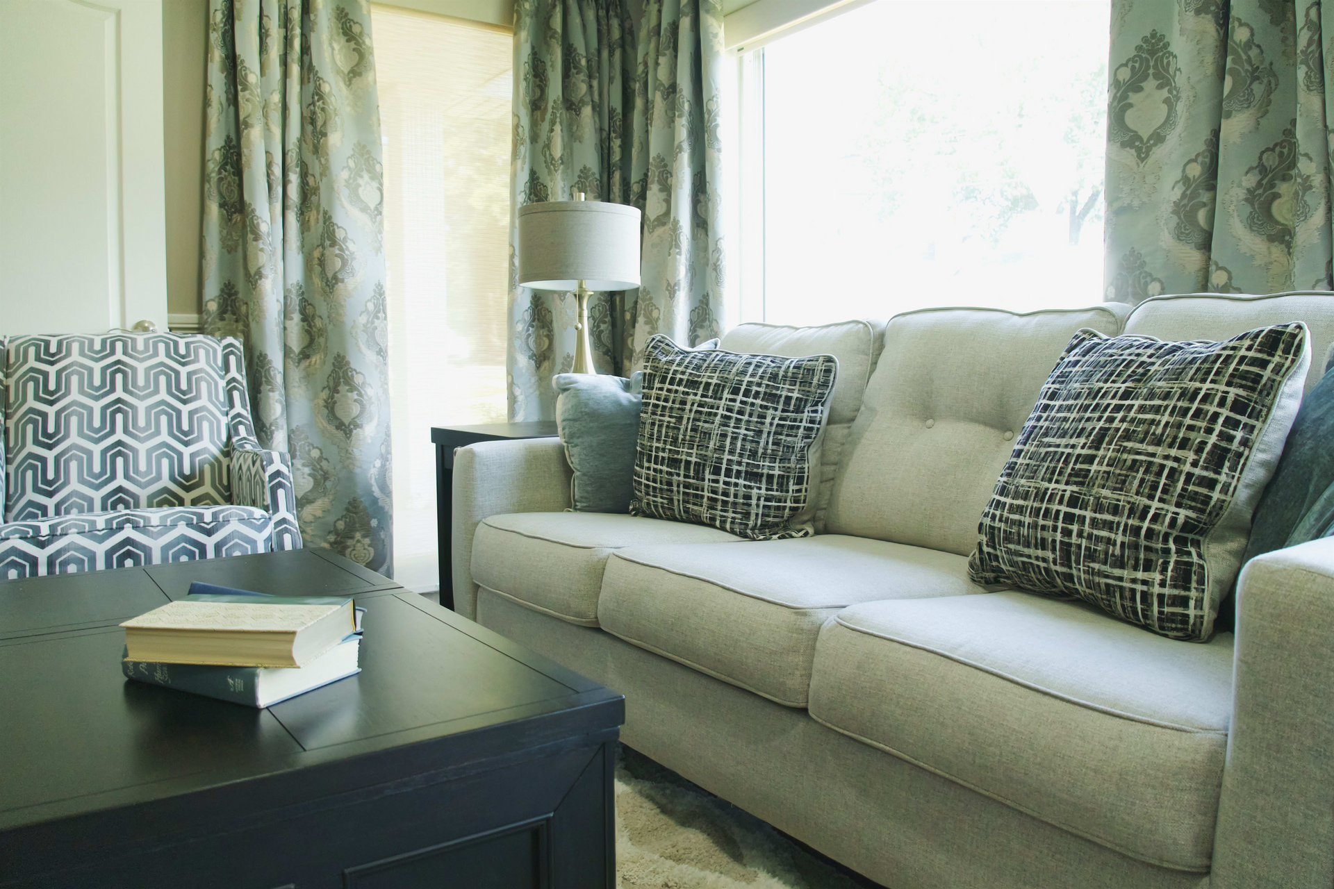 A living room with a couch , chair and coffee table