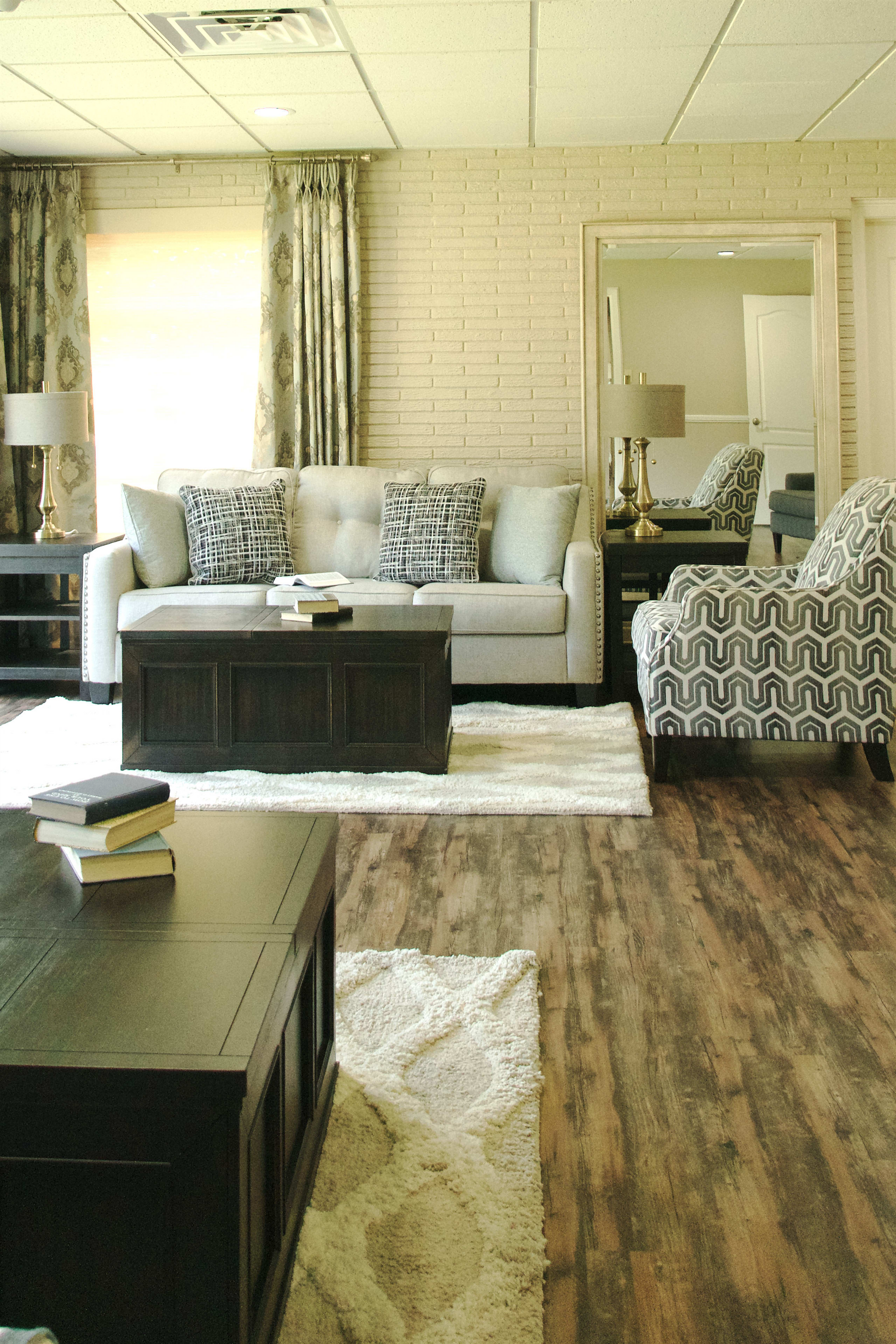A living room with a couch , chairs and a coffee table
