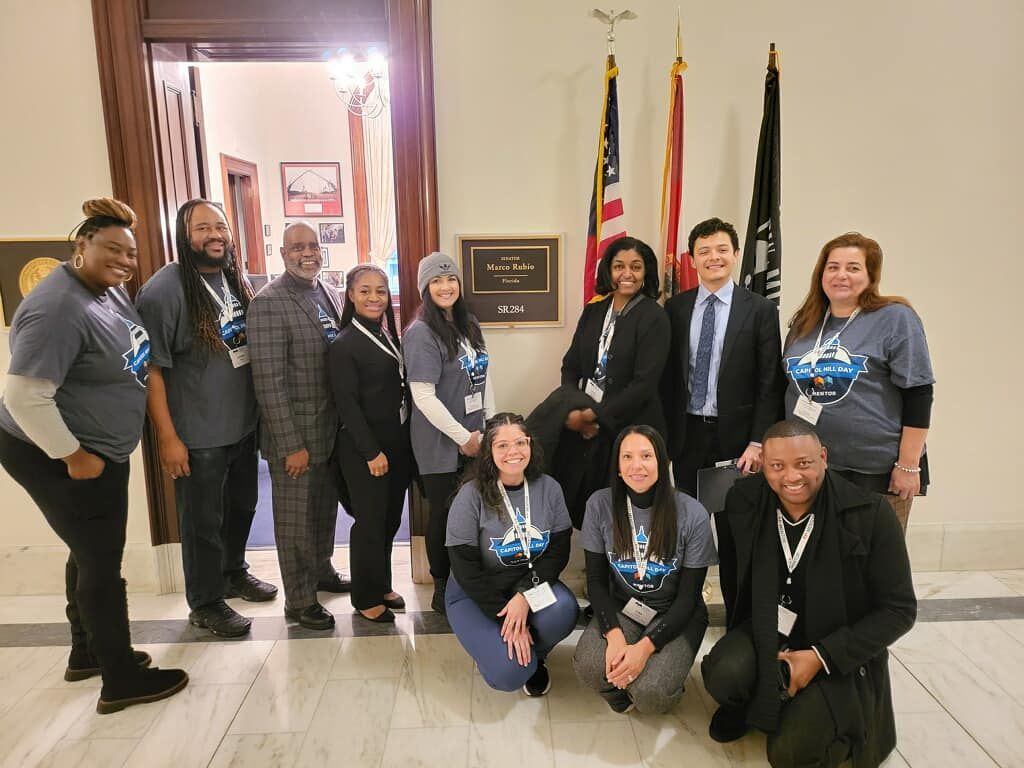 Group of people standing in front of flag