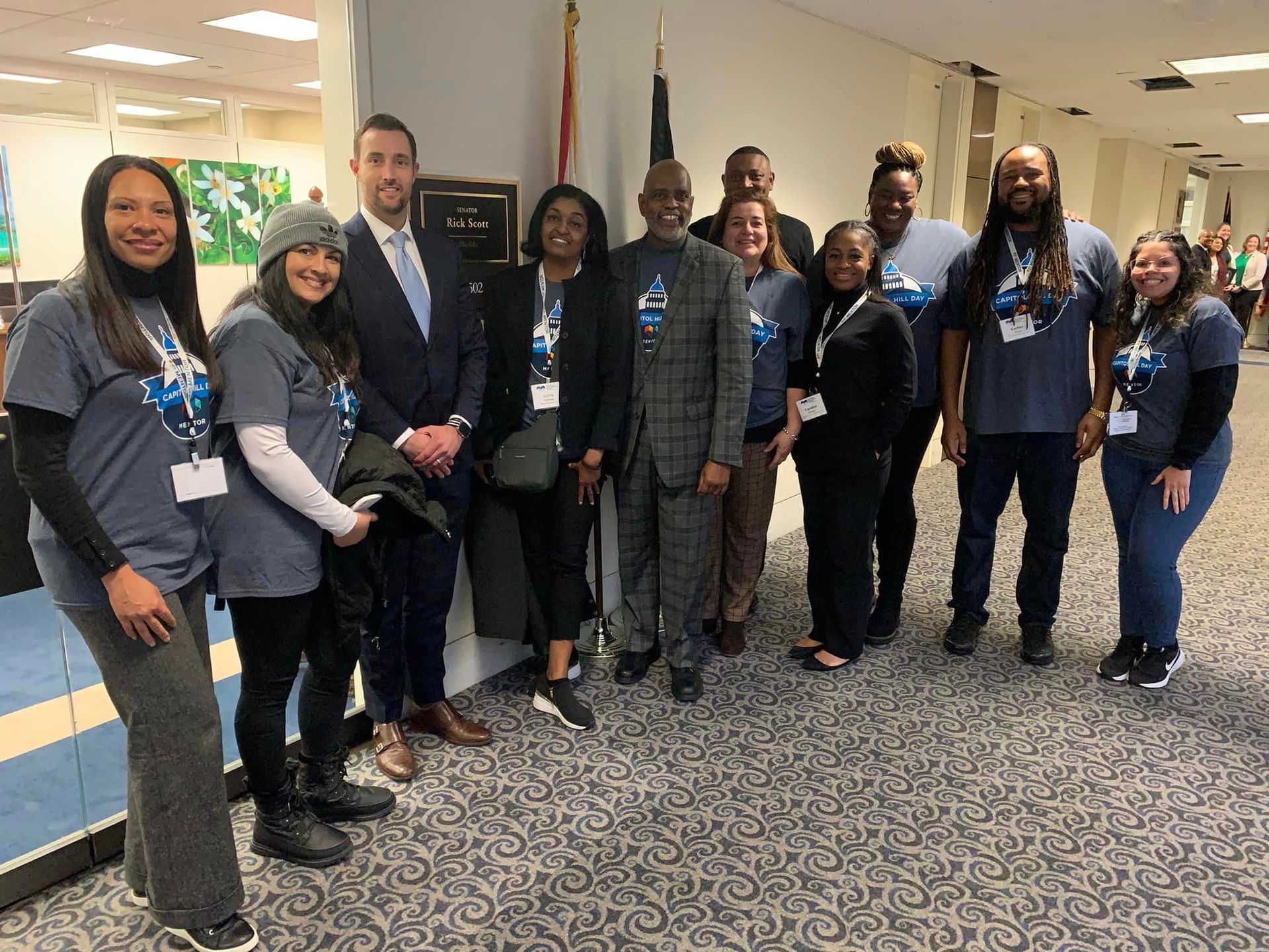 Group of people standing in front of flag