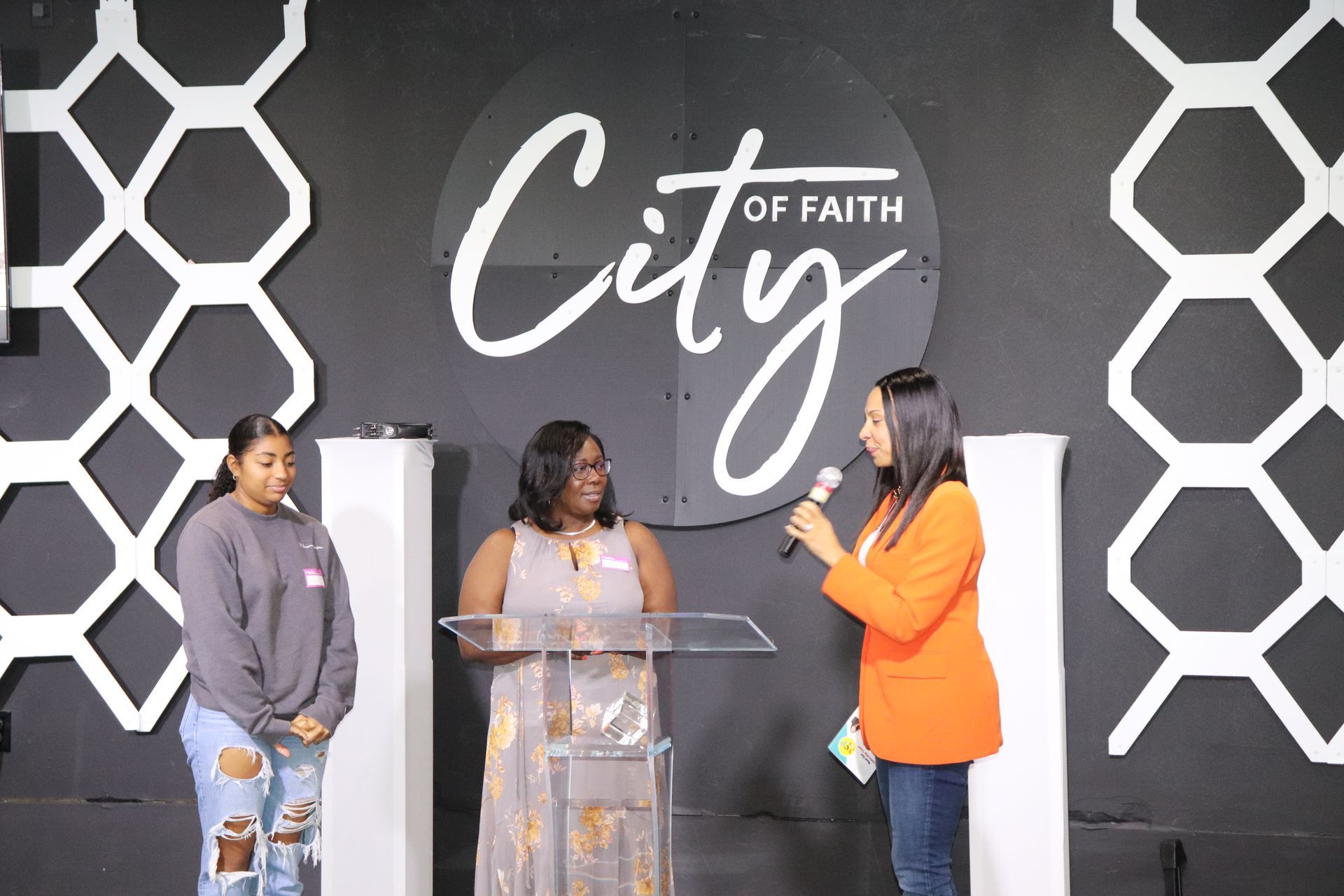 women standing up at podium with microphone