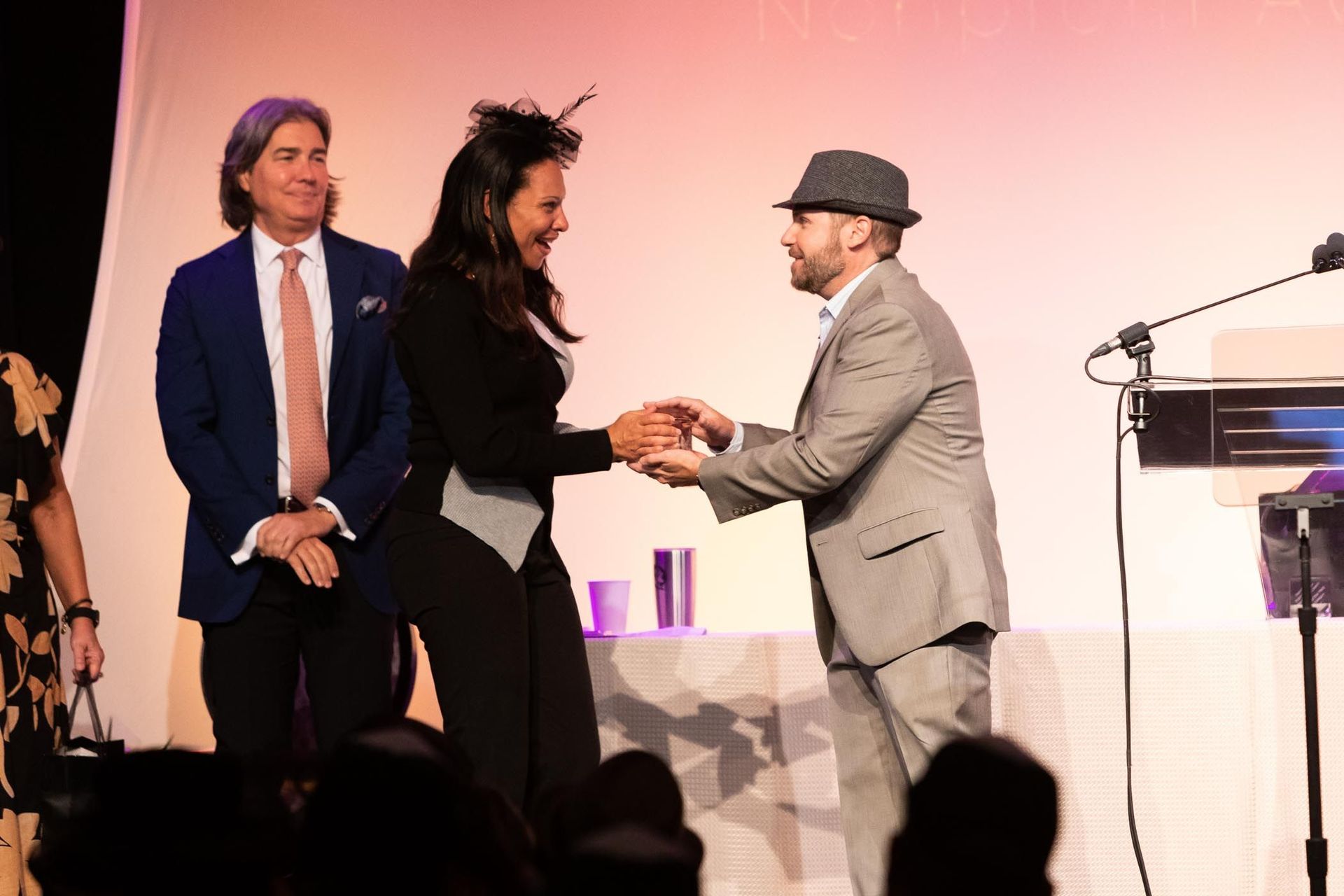 Woman and man on stage presenting an award