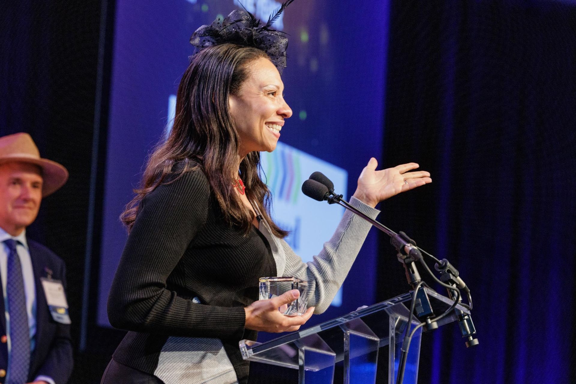 Side view of woman at podium