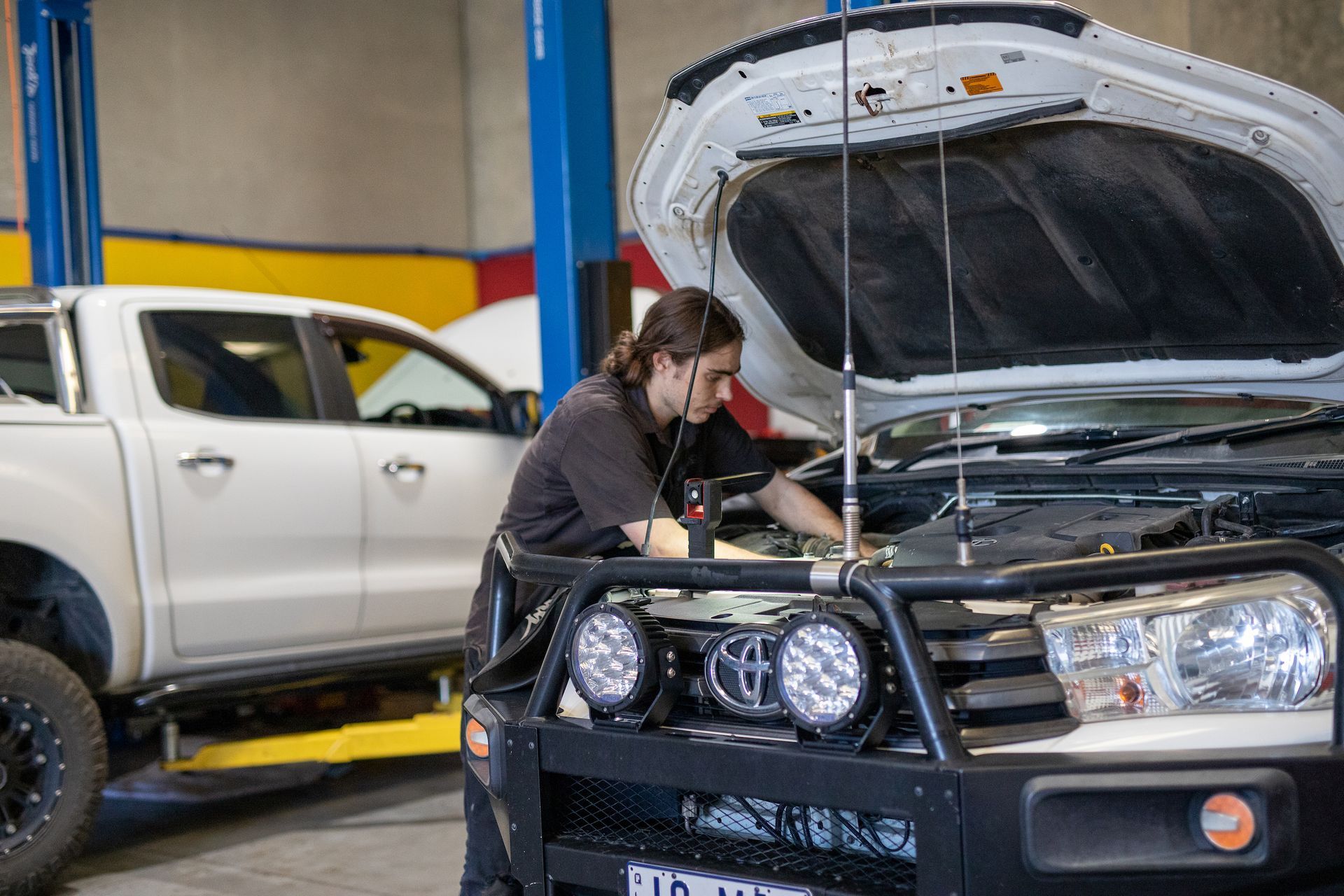 Mechanic Under The Bonnet Of A Fleet 4WD — MADD Mechanical in Paget, QLD