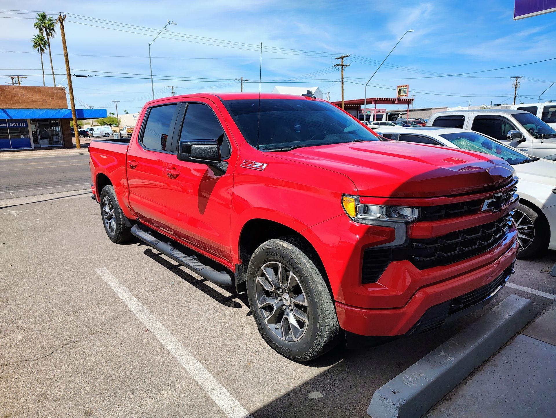 A red pickup truck is parked in a parking lot.