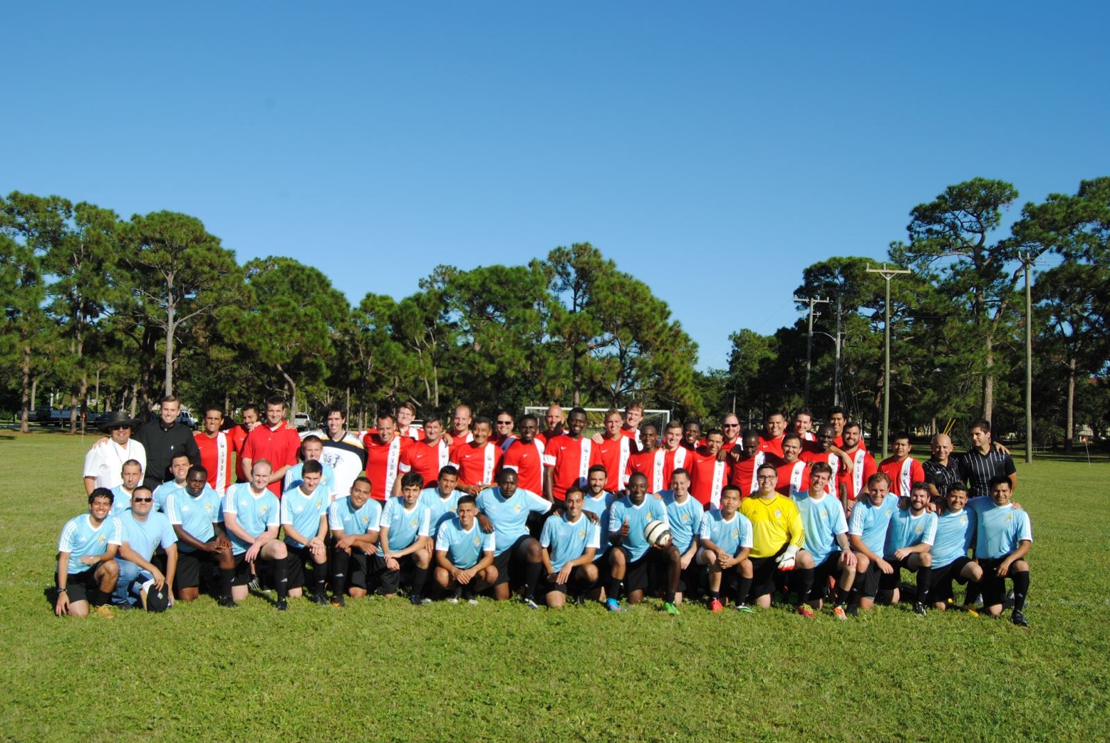 Men compete in a game of soccer, celebrate Evening Prayer, and enjoy a community dinner together.