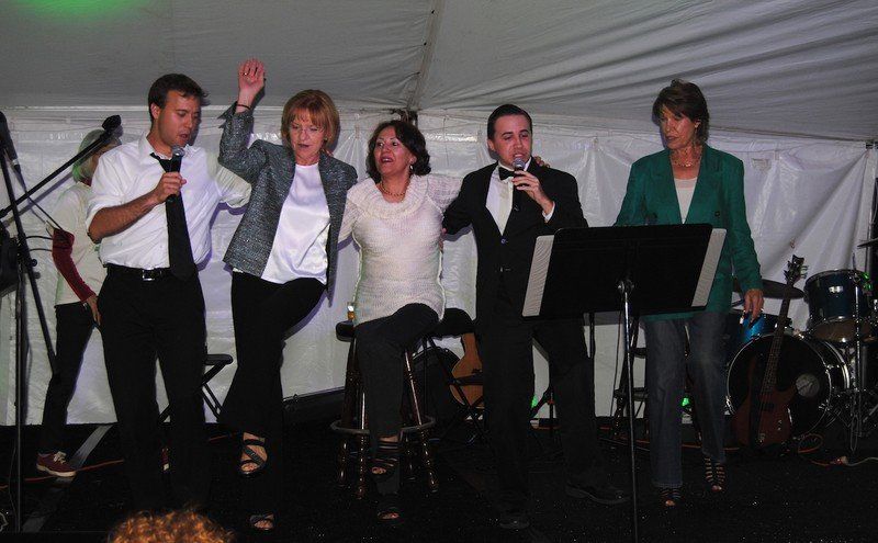 Group of people dance together.