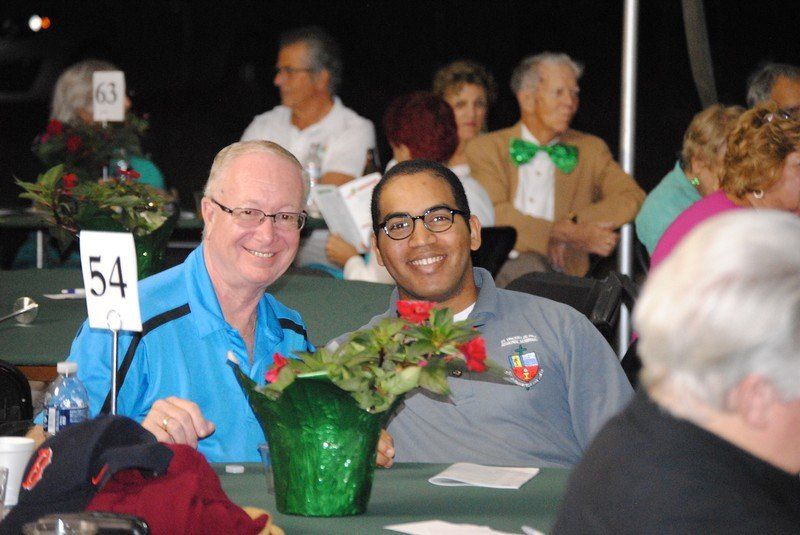 Two men smile for the camera.