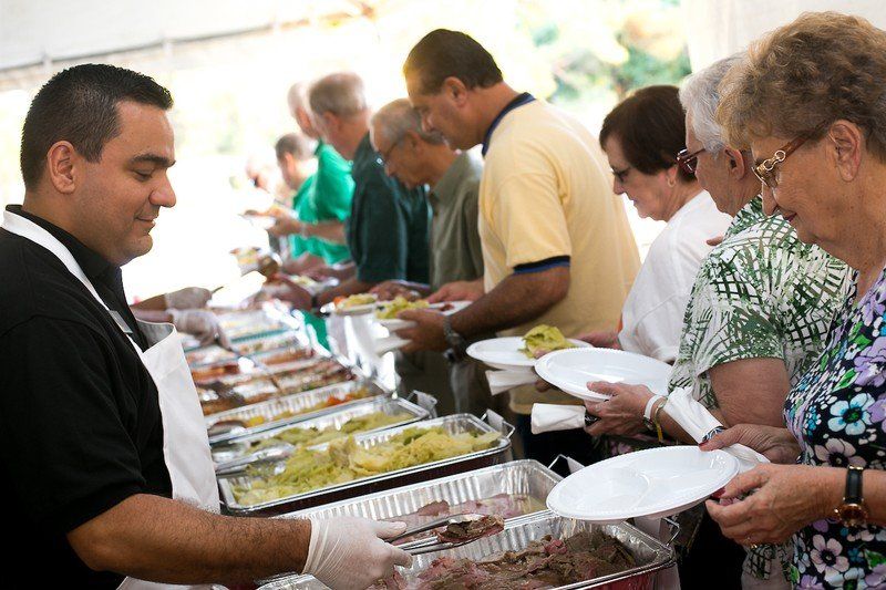 People at the buffet line getting dinner.