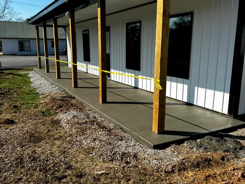 A concrete porch is being built on the side of a building.