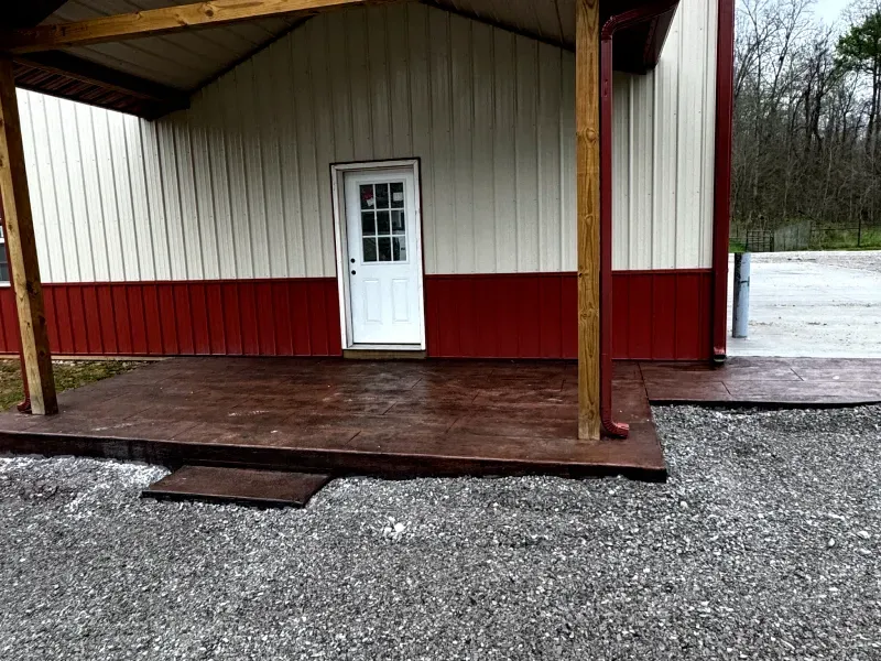 A red and white building with a porch and a white door.