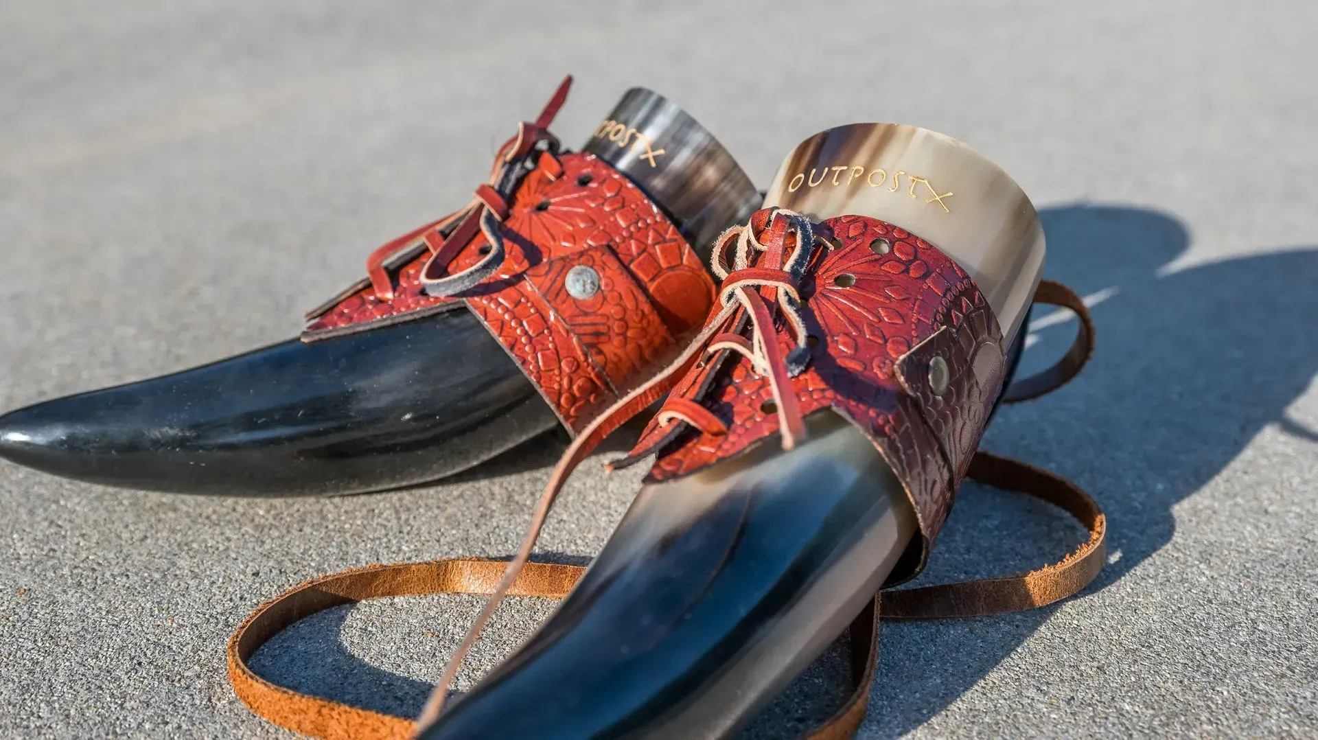 A pair of horn shoes are sitting on the ground.