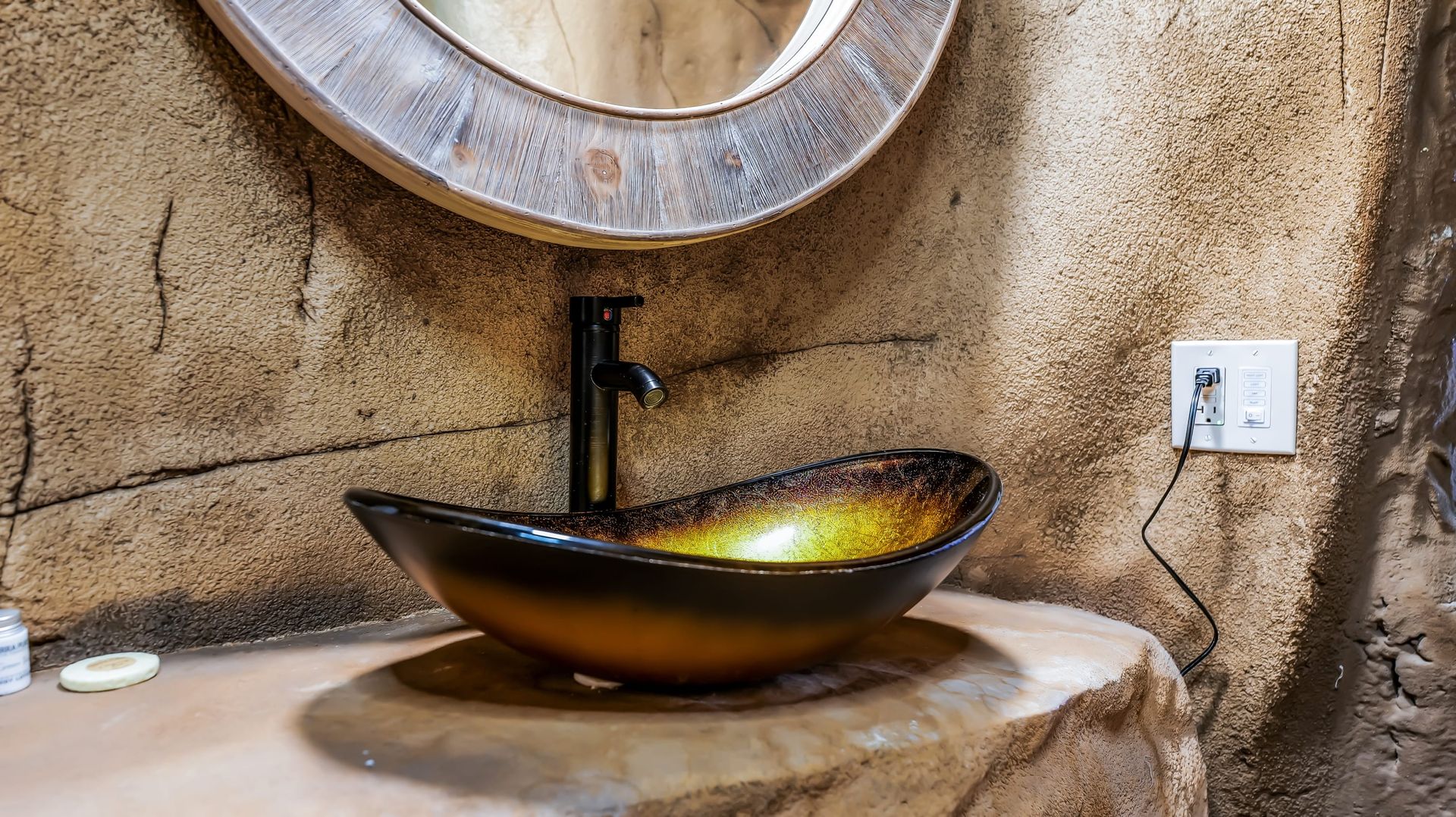A bathroom with a sink and a mirror on the wall.