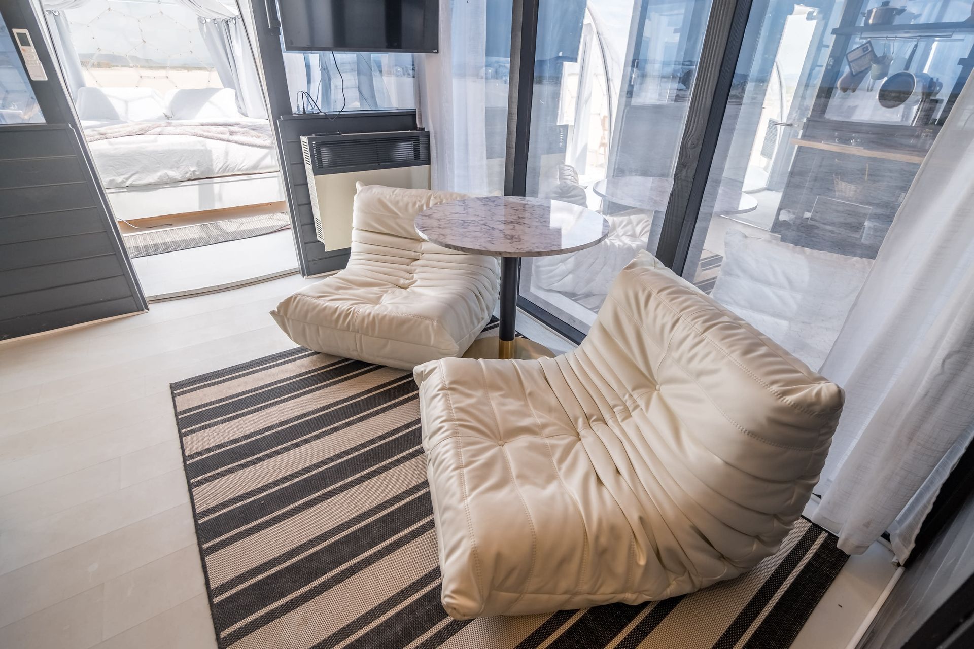 There are two chairs and a table in the room.