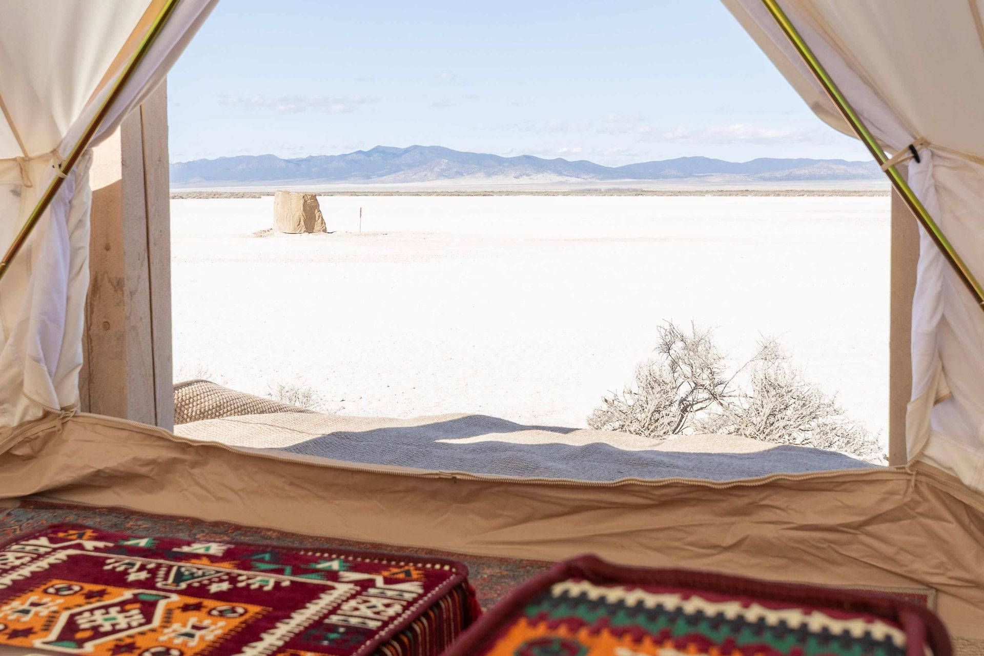 The inside of a tent with a view of the desert.