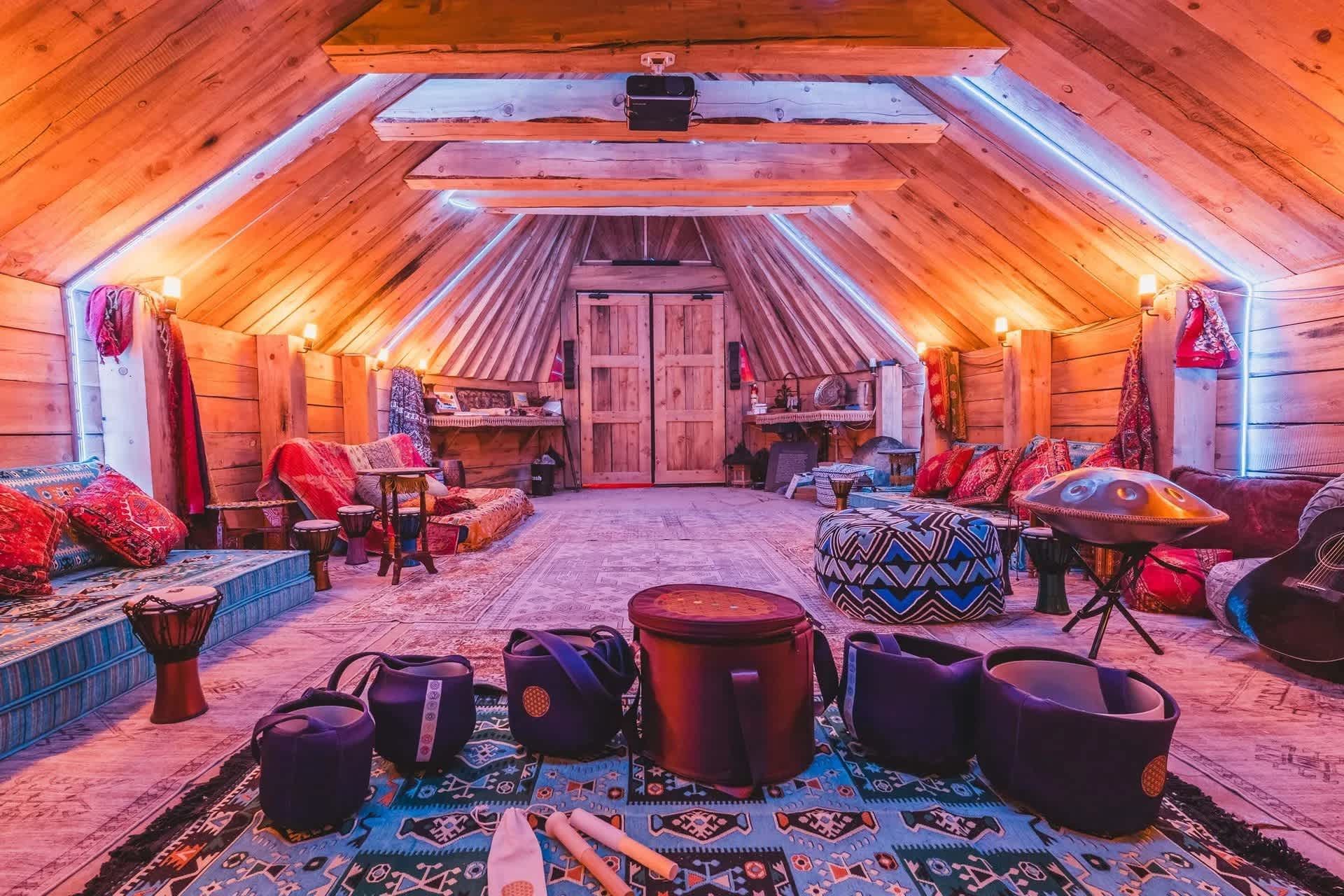 A large room with a lot of furniture and drums in it.