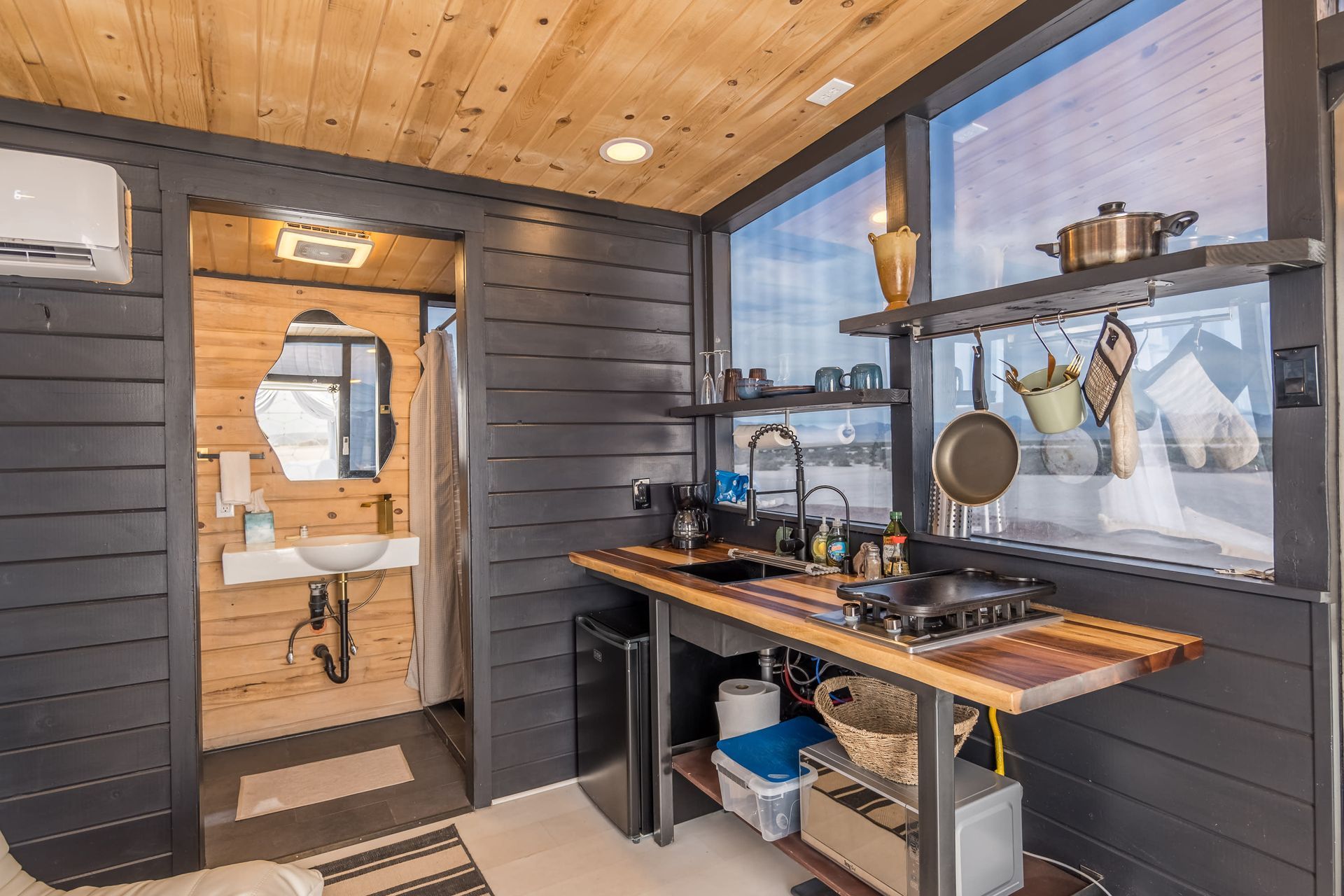 A kitchen in a small house with a sink and stove.