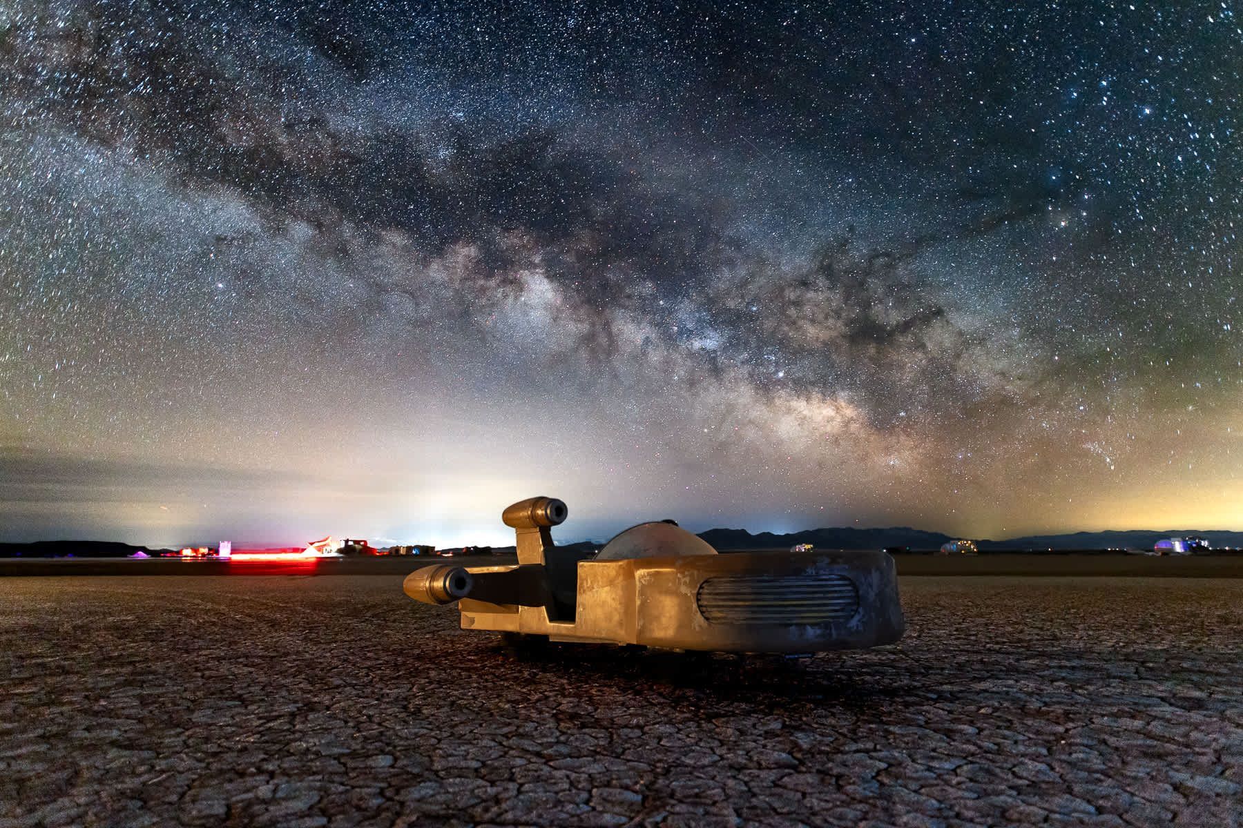 The milky way is visible in the night sky above the desert