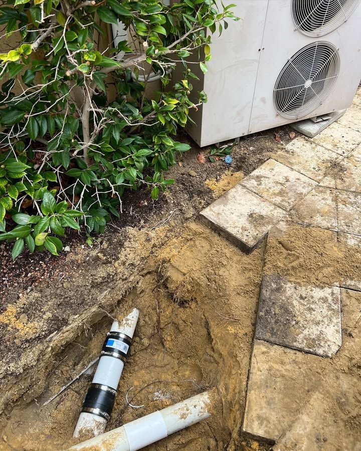Excavated Trench Next to Patio and Air Conditioner Unit — Vantage Plumbing and Drainage In Pacific Pines, QLD