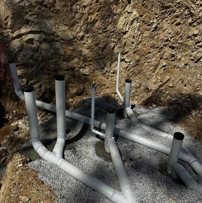 PVC Pipes and Fittings in a Gravel-lined Trench — Vantage Plumbing and Drainage In Mudgereeba, QLD