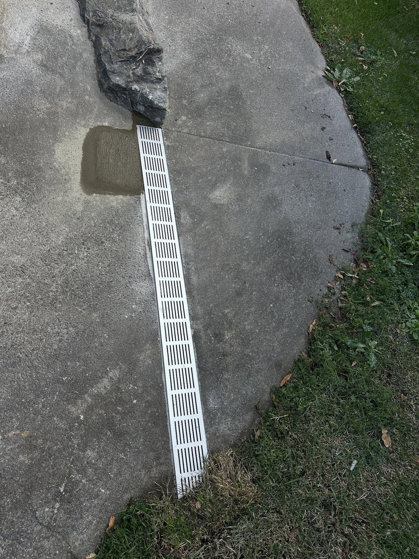 Concrete Sidewalk With a Large Drainage — Vantage Plumbing and Drainage In Nerang, QLD