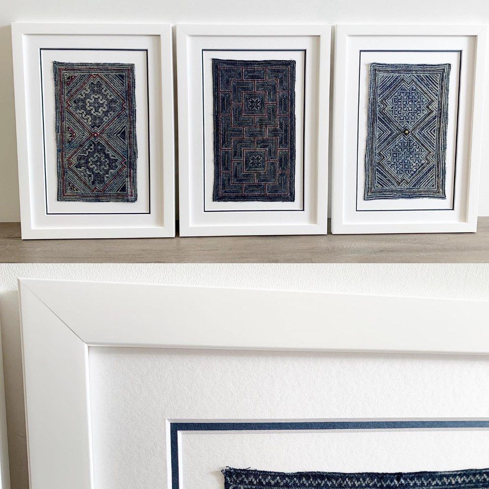 Three Framed Pictures Are Sitting on A Wooden Shelf — Framing Alternative in Erina Heights, NSW
