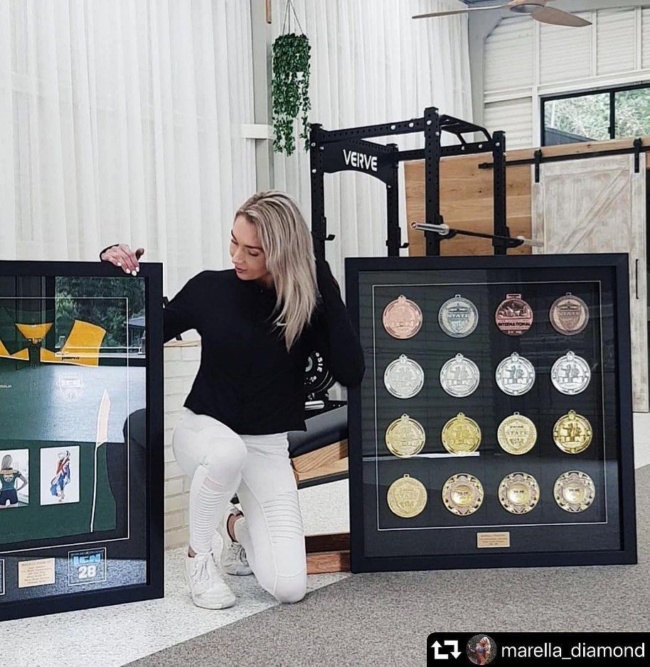 A Woman Is Kneeling in Front of A Display of Medals — Framing Alternative in Terrigal, NSW