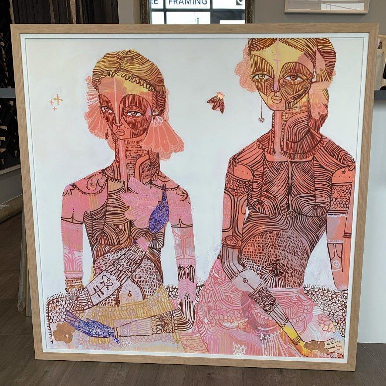 A Framed Painting of Two Women Sitting Next to Each Other — Framing Alternative in Erina Heights, NSW