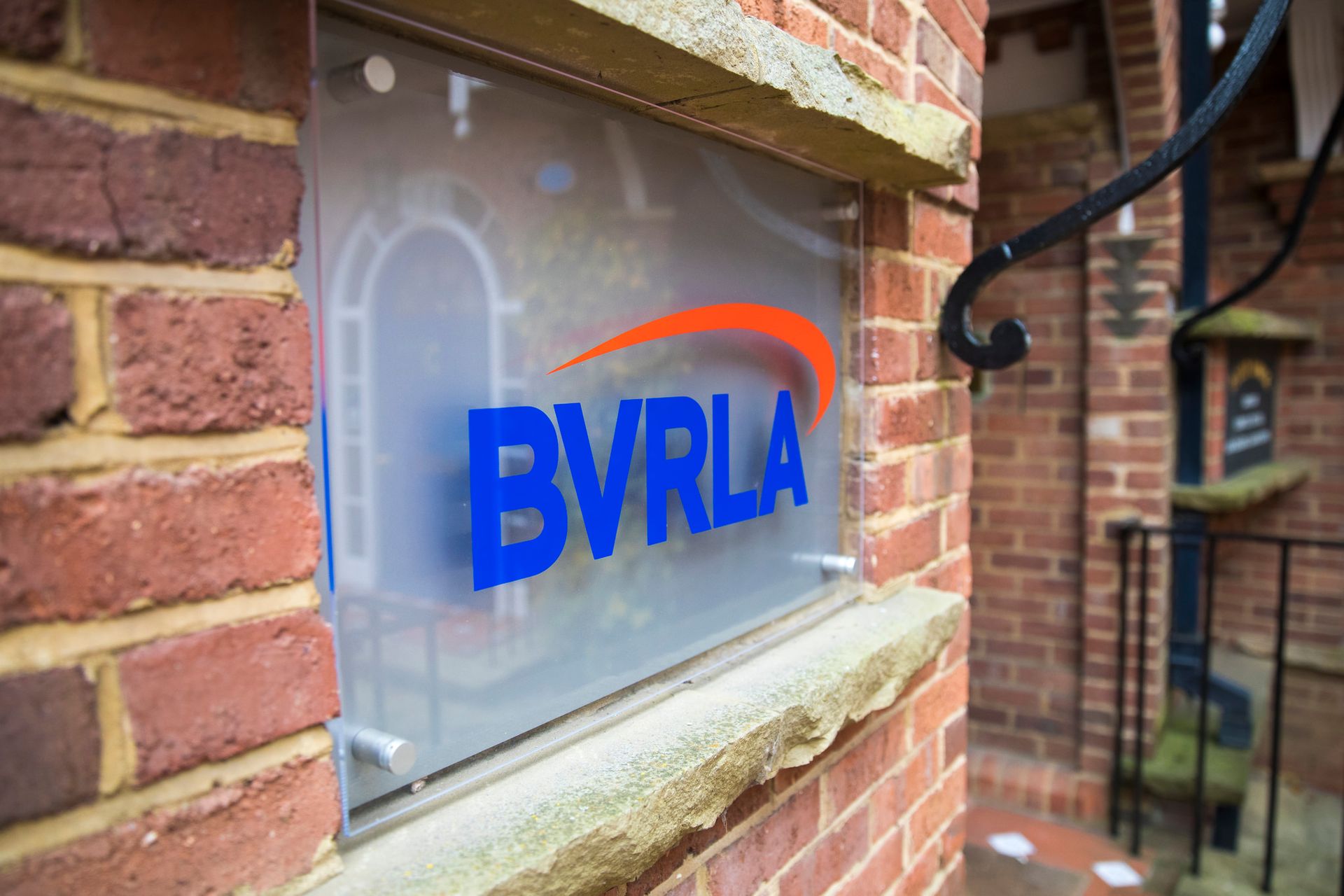 A sign on a brick wall that says BVRLA on it.