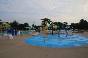 A water park with a lot of water slides and umbrellas.