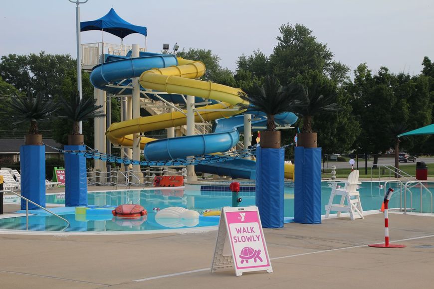 A water park with a water slide and a sign that says 