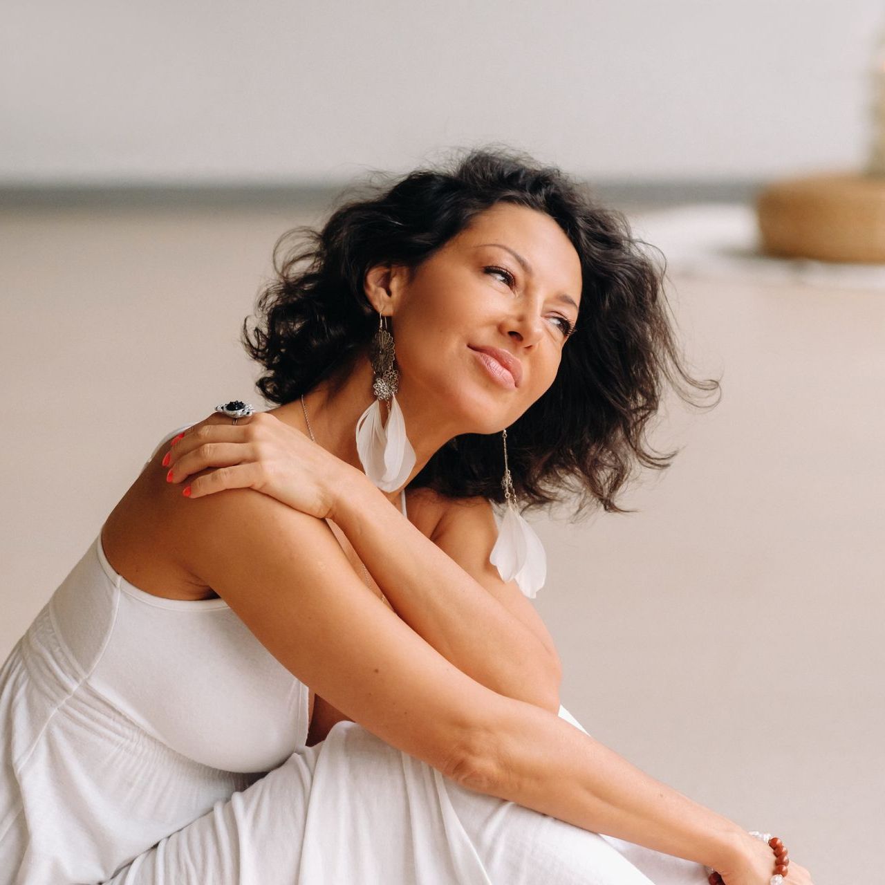 A woman with braids is smiling for the camera while wearing a red and white striped shirt.