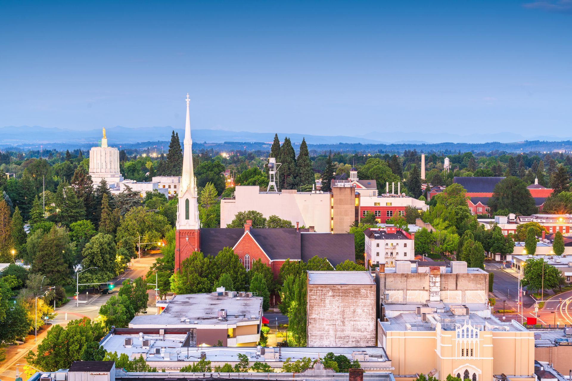 An aerial view of a city with a church in the middle of it.