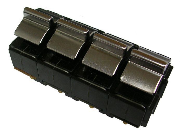 Four black rocker switches with chrome levers.