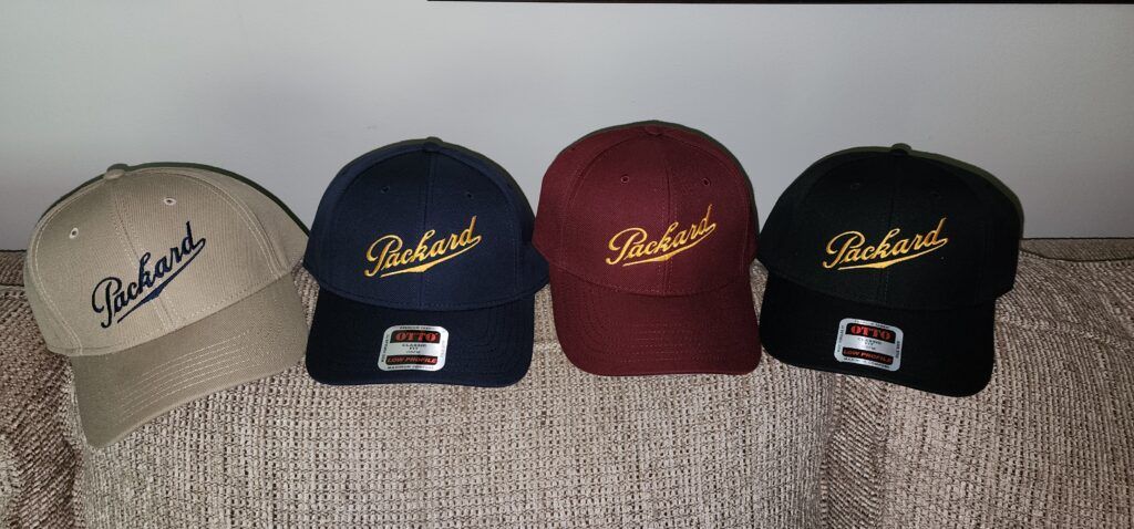 Four baseball caps of different colors, each with the word 